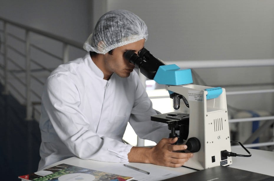 Man Looking Through Microscope