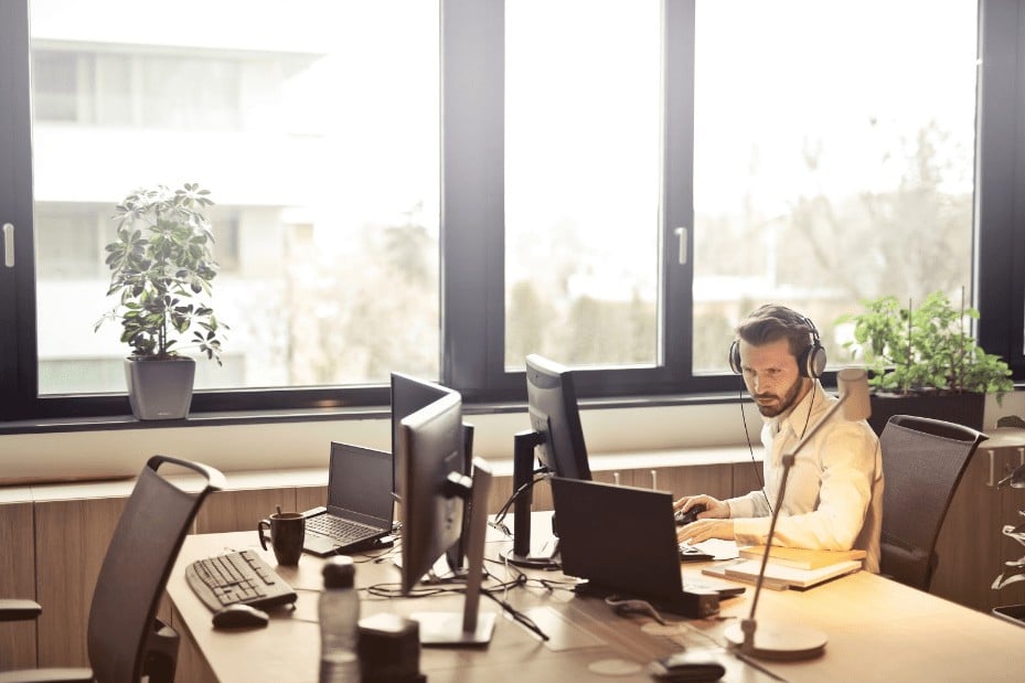 Man on Computer with Headphones