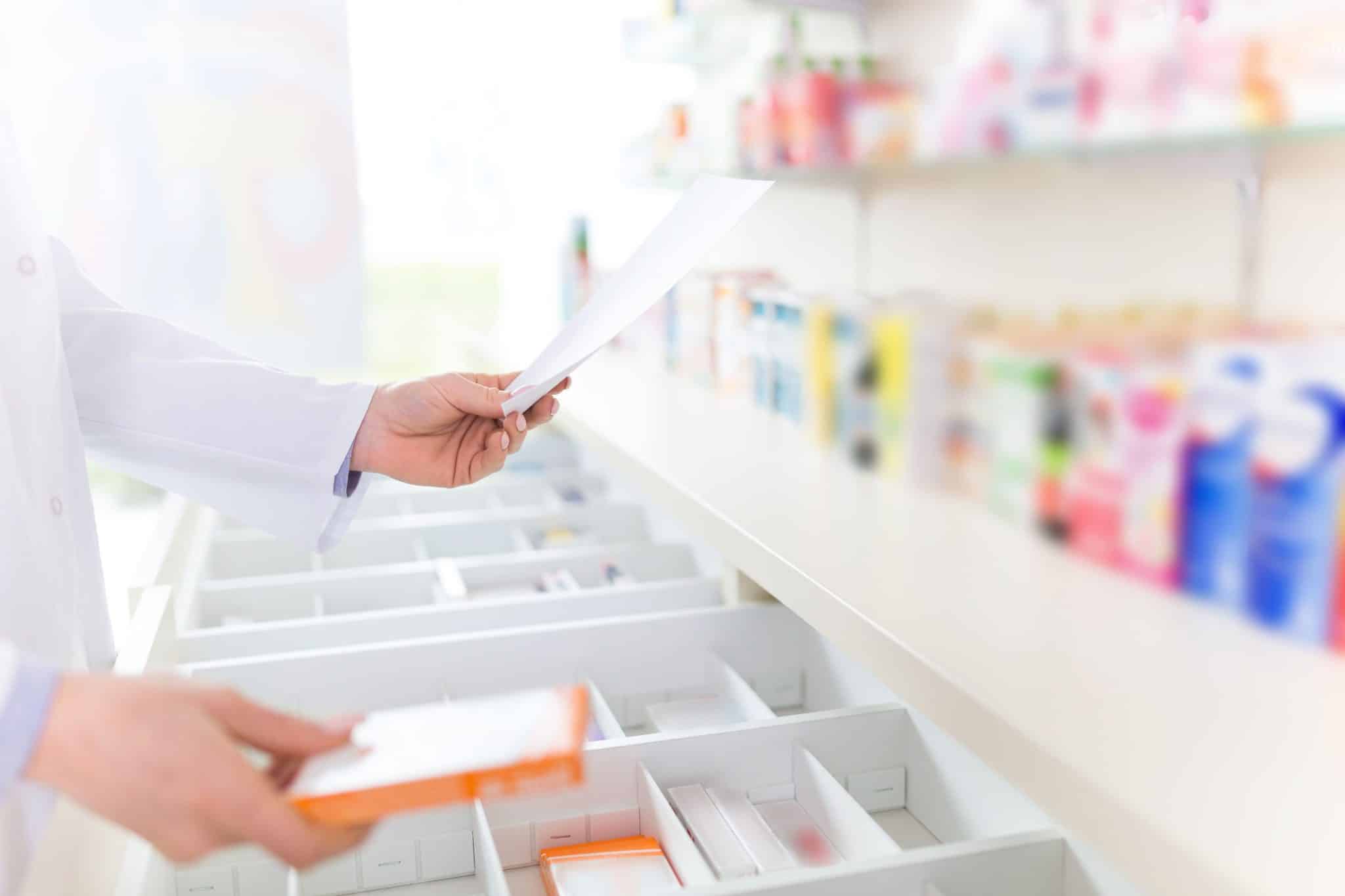Pharmacist Holding Document and Prescription Box