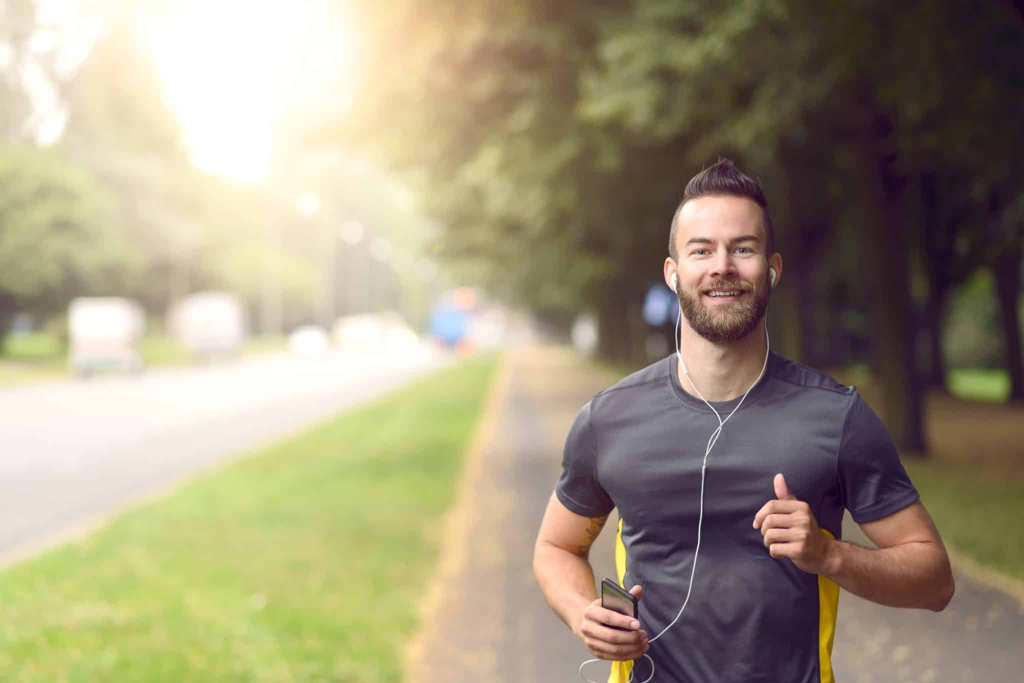 young athletic man jogging outside — IV Vitamin Therapy Benefits