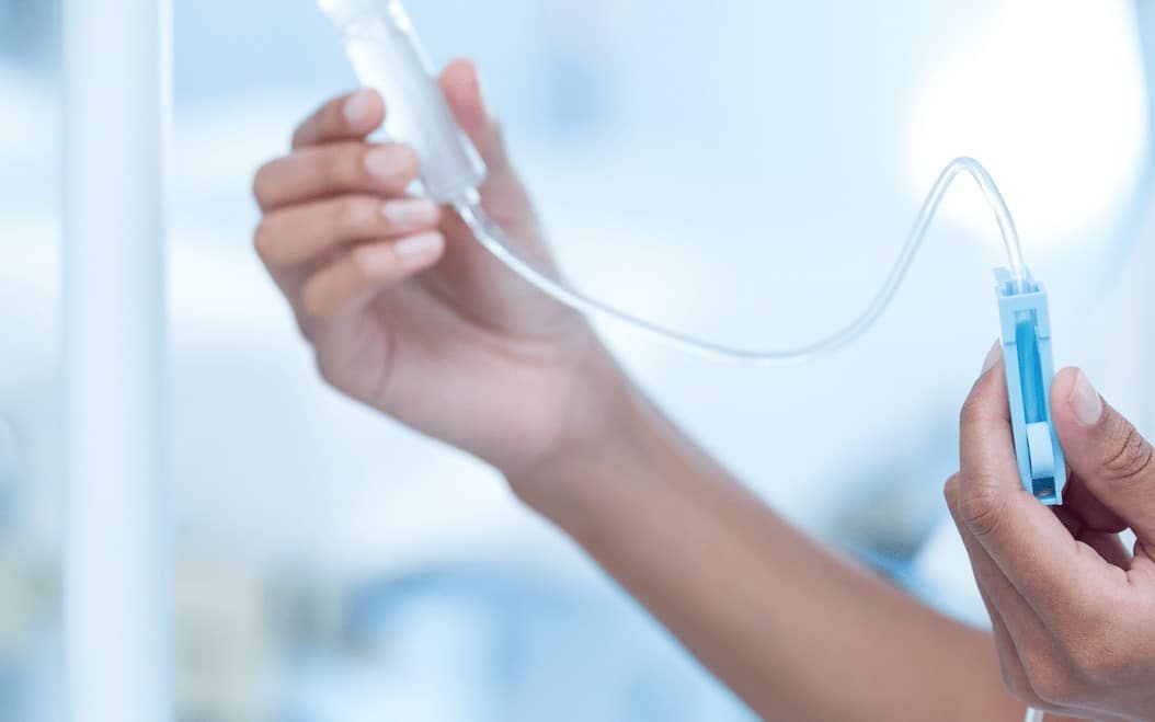 Nurse connecting an IV drip